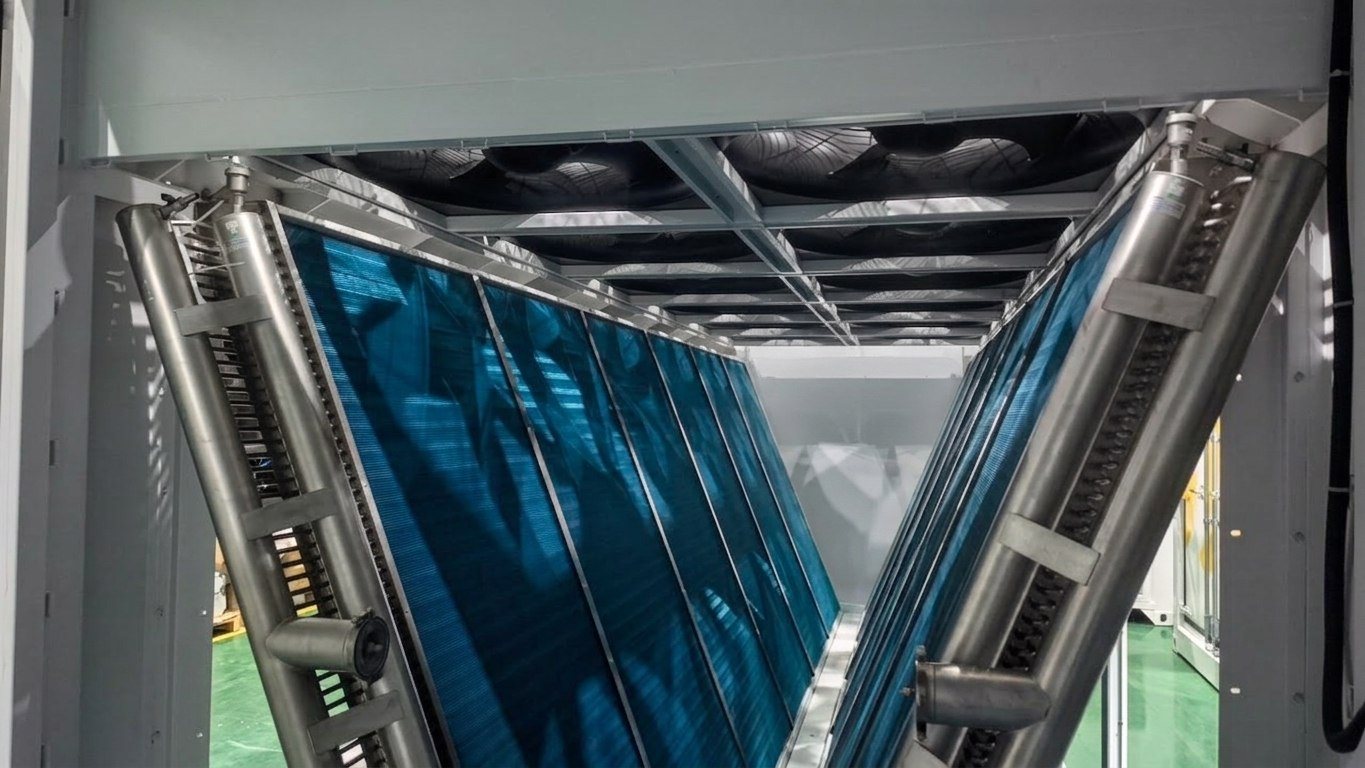 Dry cooler coils inside a hydro-cooled container