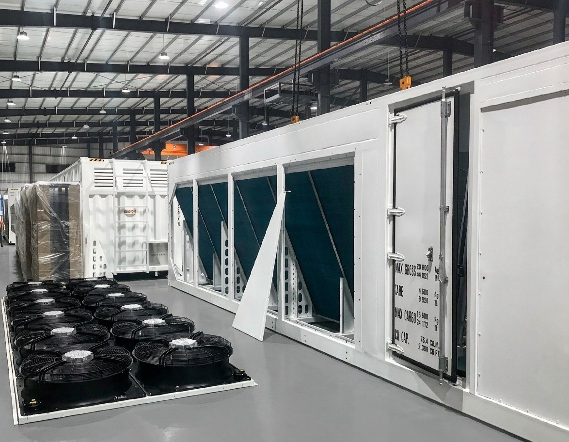 Hydro-cooled container with dry cooler coils and fan arrays during assembly